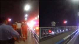 男子坐在大桥护栏上，双腿悬空欲轻生，民警声东击西将其救下
