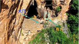 贵州一山洞口有围墙和门，无人机拍到最后洞内冒出一个人，吓一跳